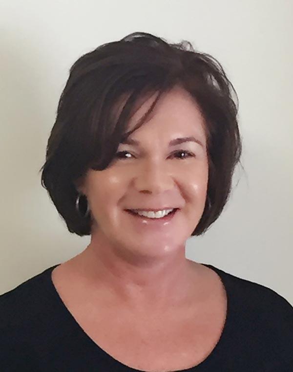 smiling woman with brown hair and black shirt